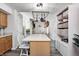 Kitchen island with barstool seating and overhead hanging pot rack, plus storage, creates a functional gathering space at 852 Yellowwood Dr, Greenwood, IN 46143