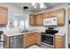 Charming kitchen featuring wood cabinetry, stainless steel appliances, and a view to the outside offers both convenience and a welcoming atmosphere at 852 Yellowwood Dr, Greenwood, IN 46143