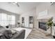 Bright living room featuring a brick fireplace, ceiling fan, and white cabinets at 852 Yellowwood Dr, Greenwood, IN 46143