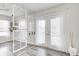 Airy living room featuring stylish decor, a decorative window display and French doors leading to the deck at 852 Yellowwood Dr, Greenwood, IN 46143