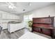 Multipurpose living area with white cabinets, workspace and a piano offers versatility and room to unwind at 852 Yellowwood Dr, Greenwood, IN 46143