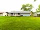 Large, grassy backyard featuring a small wood deck perfect for entertaining at 8609 Stonewall Dr, Indianapolis, IN 46231