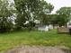 Large backyard with a shed, trees, and lots of green space at 8609 Stonewall Dr, Indianapolis, IN 46231