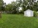 Large backyard featuring a shed and plenty of green space at 8609 Stonewall Dr, Indianapolis, IN 46231