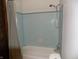 Bathroom with a shower and tub combination, featuring blue tile at 8609 Stonewall Dr, Indianapolis, IN 46231