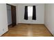 Bedroom with laminate flooring, natural light, and closet space at 8609 Stonewall Dr, Indianapolis, IN 46231