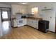 Kitchen boasts wood floors, white cabinets, and modern appliances at 8609 Stonewall Dr, Indianapolis, IN 46231