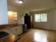 Well-lit kitchen featuring wood floors, white cabinets, and stainless appliances at 8609 Stonewall Dr, Indianapolis, IN 46231