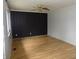 Bright living room with wood floors, black accent wall, and ample light at 8609 Stonewall Dr, Indianapolis, IN 46231