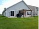 Spacious backyard with a well-maintained lawn, patio, and pergola, perfect for outdoor entertaining and relaxation at 878 Sommersweet Run, Greenwood, IN 46143