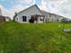 Spacious backyard with a well-maintained lawn, patio, and pergola, perfect for outdoor entertaining and relaxation at 878 Sommersweet Run, Greenwood, IN 46143
