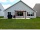 A backyard with a patio area covered by a pergola and a green, well-kept lawn at 878 Sommersweet Run, Greenwood, IN 46143