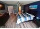 Bedroom featuring a striped bedspread, ceiling fan, and natural light from the window at 878 Sommersweet Run, Greenwood, IN 46143