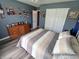 Comfortable bedroom with wood floors, dresser, and closet space at 878 Sommersweet Run, Greenwood, IN 46143