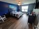 Bright bedroom with a ceiling fan, large window and a beach scene wall decor at 878 Sommersweet Run, Greenwood, IN 46143