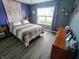 Comfortable bedroom with natural light, wood floors, a ceiling fan, and tasteful decor for a serene feel at 878 Sommersweet Run, Greenwood, IN 46143
