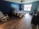 Bedroom featuring a striped bedspread, ceiling fan, and natural light from the window at 878 Sommersweet Run, Greenwood, IN 46143