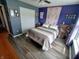 Bedroom with ample space, featuring light wood floors and dual closet doors to maximize storage options at 878 Sommersweet Run, Greenwood, IN 46143