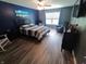 Bright bedroom with a ceiling fan, large window and a beach scene wall decor at 878 Sommersweet Run, Greenwood, IN 46143
