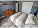 Large bedroom with ample space, featuring light wood floors and a stylish dresser against a blue accent wall at 878 Sommersweet Run, Greenwood, IN 46143