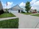 Well-kept home featuring a spacious two-car garage, well-manicured lawn, and nearby parking at 878 Sommersweet Run, Greenwood, IN 46143