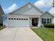 Charming single-Gathering home featuring a two-car garage, well-manicured lawn, and lush landscaping at 878 Sommersweet Run, Greenwood, IN 46143