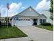 Charming single-Gathering home featuring a two-car garage, well-manicured lawn, and flag at 878 Sommersweet Run, Greenwood, IN 46143