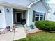 Inviting front porch with a cozy seating area, decorative plants, and a well-manicured front garden at 878 Sommersweet Run, Greenwood, IN 46143