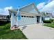 Well-kept home featuring a spacious two-car garage, blue exterior lights, and neat landscaping at 878 Sommersweet Run, Greenwood, IN 46143
