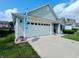 Well-kept home featuring a spacious two-car garage, blue exterior lights, and neat landscaping at 878 Sommersweet Run, Greenwood, IN 46143
