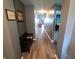Inviting hallway with wood floors, bench seat, and neutral paint tone, providing a comfortable atmosphere at 878 Sommersweet Run, Greenwood, IN 46143