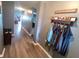 Welcoming hallway with hardwood floors and convenient wall-mounted coat rack and display shelf at 878 Sommersweet Run, Greenwood, IN 46143