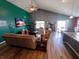Spacious living room with vaulted ceilings and seamless transition to the dining area at 878 Sommersweet Run, Greenwood, IN 46143