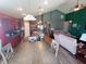 Open-concept living space boasts modern kitchen with island and a large dining table with a view to the living room at 878 Sommersweet Run, Greenwood, IN 46143