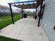 Patio with pergola offers a shaded outdoor living space, adjacent to a well-maintained lawn at 878 Sommersweet Run, Greenwood, IN 46143