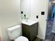 Cozy bathroom with a dark wood vanity, matching toilet, and a mirror at 883 Halyard Dr, Avon, IN 46123