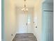 Bright foyer featuring wood-look flooring, a modern light fixture, and convenient closet space at 883 Halyard Dr, Avon, IN 46123