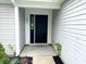 Welcoming entryway with a stylish black front door, decorative accents, and freshly landscaped surroundings at 883 Halyard Dr, Avon, IN 46123
