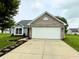 Inviting single-story home featuring a brick facade, bay window, manicured lawn, and spacious driveway at 883 Halyard Dr, Avon, IN 46123