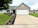 Lovely single-story home with a well-manicured lawn, brick details, and an attached two-car garage at 883 Halyard Dr, Avon, IN 46123