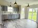 Bright eat-in kitchen featuring gray cabinets, stainless appliances and sliding door to the backyard at 883 Halyard Dr, Avon, IN 46123