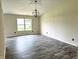 Spacious living room with ample natural light, wood-look flooring, and modern light fixtures at 883 Halyard Dr, Avon, IN 46123
