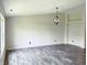 Inviting living room with wood-look flooring, a contemporary light fixture, and neutral paint at 883 Halyard Dr, Avon, IN 46123