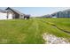 Large backyard with a small drainage creek, shed and view of other homes at 9001 Fitzgerald Dr, Indianapolis, IN 46239