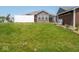 Spacious, grassy backyard with privacy fence, small storage building, and patio at 9001 Fitzgerald Dr, Indianapolis, IN 46239