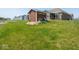 View of the backyard, featuring a small shed and part of the home's patio at 9001 Fitzgerald Dr, Indianapolis, IN 46239