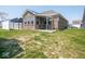 Spacious backyard featuring a covered patio, perfect for outdoor relaxation and entertaining at 9001 Fitzgerald Dr, Indianapolis, IN 46239
