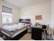 Bright, clean bedroom with a large window, neutral walls, and a built-in desk area at 9001 Fitzgerald Dr, Indianapolis, IN 46239
