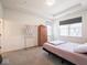 Bright bedroom featuring neutral walls, carpeted floors, and a wardrobe with a view to the outside at 9001 Fitzgerald Dr, Indianapolis, IN 46239