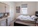 Inviting bedroom features a dark bed frame, window with blinds, and a white cabinet at 9001 Fitzgerald Dr, Indianapolis, IN 46239